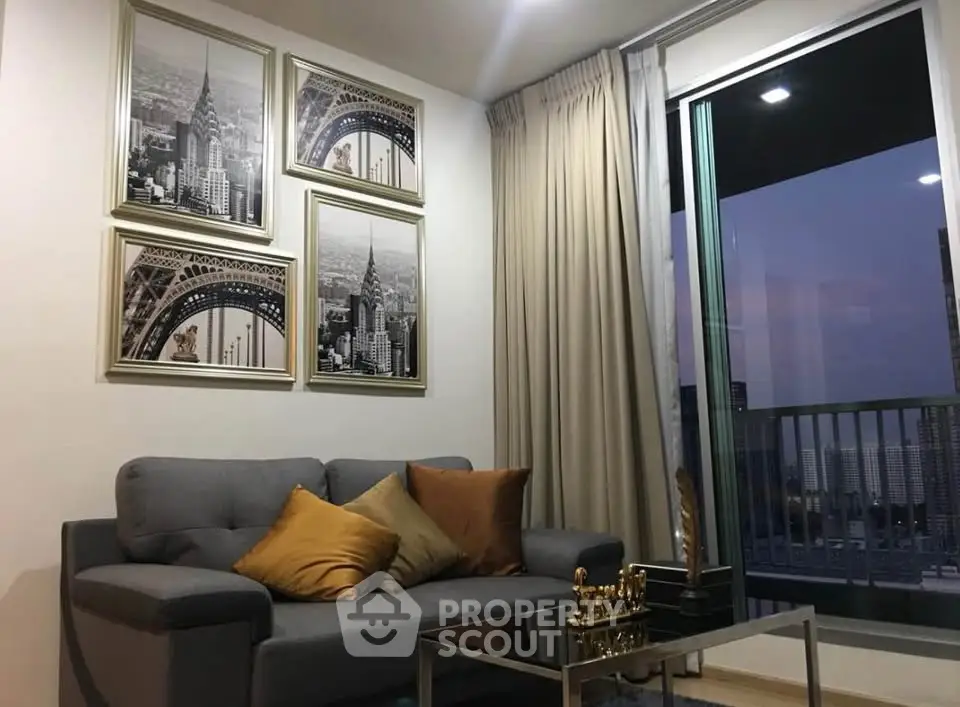 Stylish living room with modern decor and city view balcony, perfect for urban living.