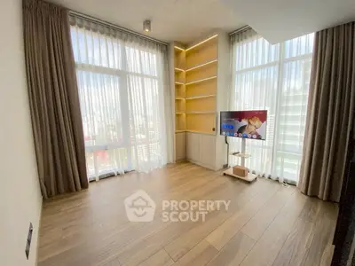 Spacious modern living room with floor-to-ceiling windows and city view