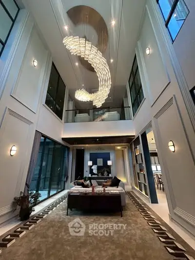 Luxurious modern living room with high ceilings and elegant chandelier