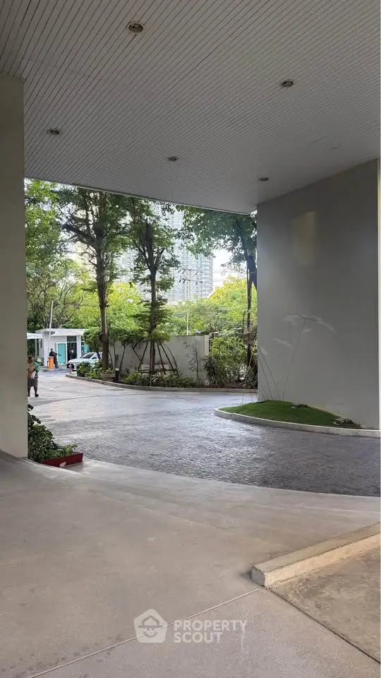 Elegant building entrance with lush greenery and modern design