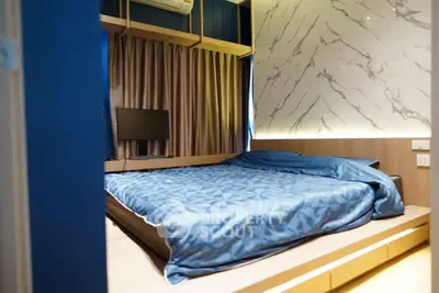 Modern bedroom with stylish marble accent wall and cozy blue bedding