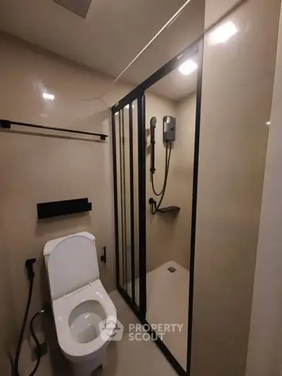 Modern bathroom with sleek shower and toilet in compact design