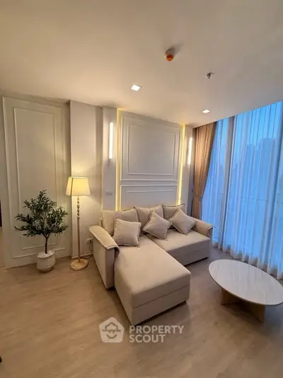 Elegant living room with cozy sofa and city view, perfect for relaxation.