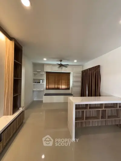 Modern living room with sleek built-in shelves and elegant window treatments