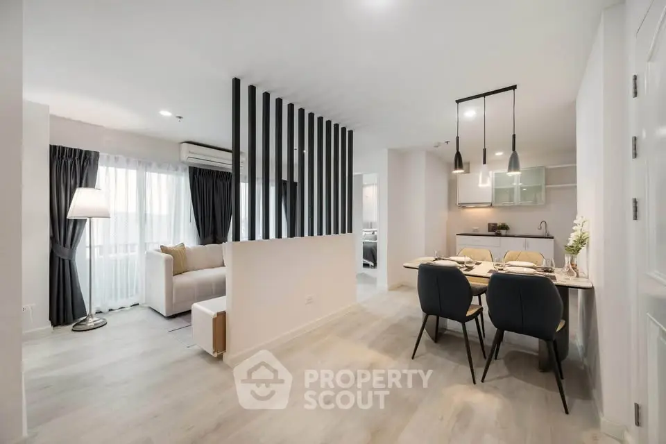 Modern open-plan living and dining area with stylish decor and natural light.