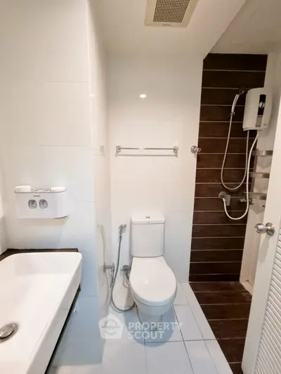 Modern bathroom with sleek fixtures and shower area in a contemporary home.