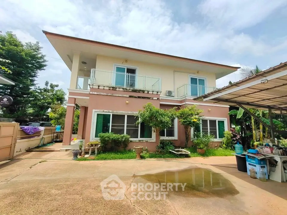 Charming two-story house with lush greenery and spacious driveway