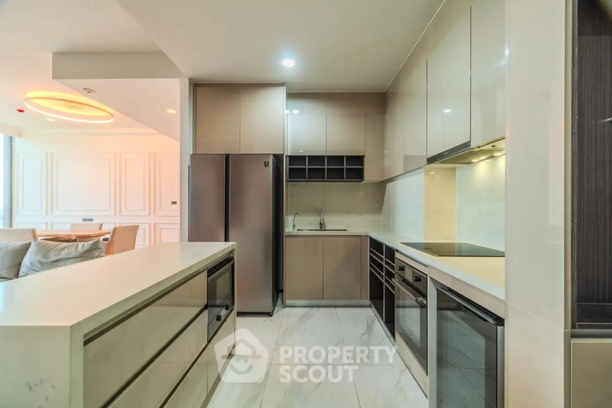 Luxurious modern kitchen with sleek cabinetry and high-end appliances in open layout design.