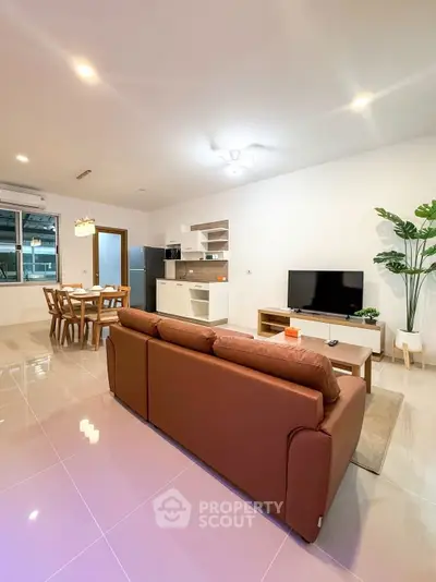 Spacious modern living room with open kitchen and stylish decor