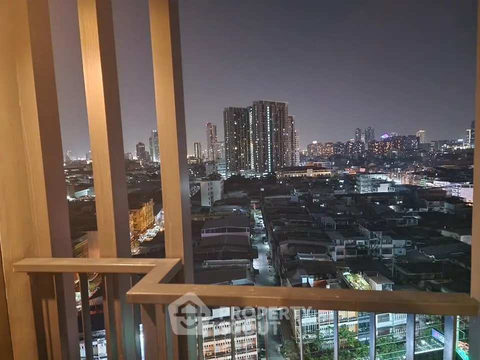 Stunning cityscape view from a modern balcony at night, showcasing urban living.