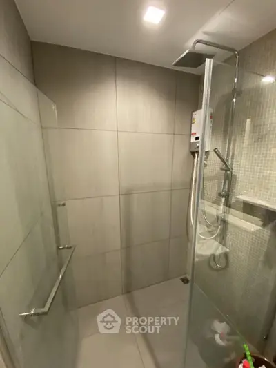 Modern bathroom with glass shower enclosure and sleek fixtures