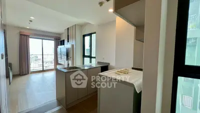 Modern open-layout kitchen with city view from balcony in high-rise apartment