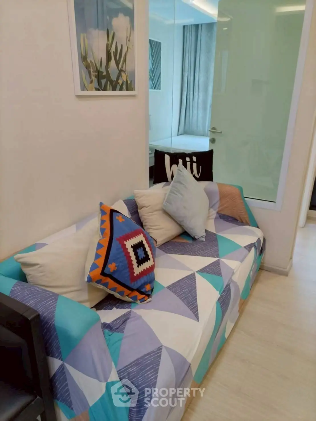 Cozy living room with colorful geometric-patterned sofa and modern decor