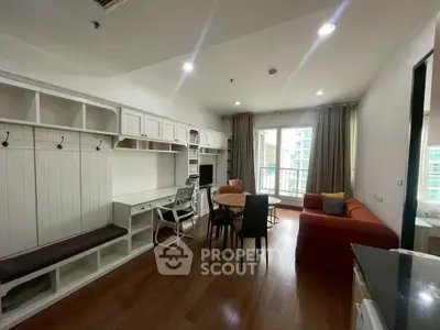 Modern living room with wooden flooring, cozy sofa, and balcony view in a stylish apartment.