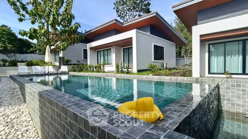 Modern villa with private pool and lush garden, perfect for luxury living.