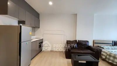 Modern studio apartment with sleek kitchen and cozy living area