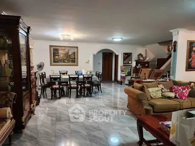 Spacious living room with elegant dining area and marble flooring