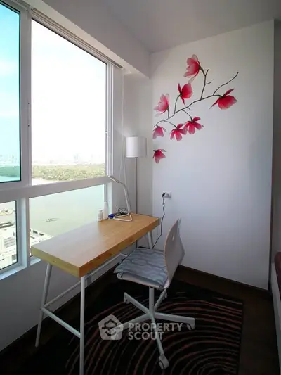 Bright study nook with floral wall art and city view, perfect for productivity and inspiration.