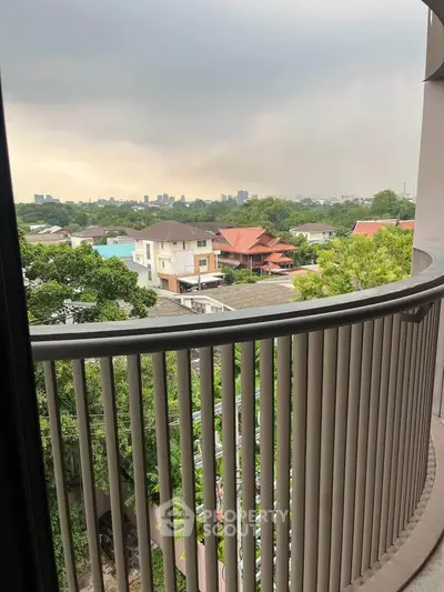 Stunning balcony view overlooking lush greenery and city skyline, perfect for relaxation and enjoying the outdoors.