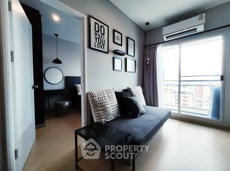 Modern living room with stylish decor and city view balcony