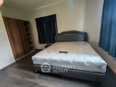 Spacious bedroom with elegant bed and ample closet space