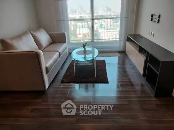 Modern living room with city view, sleek wooden floors, and stylish furniture.