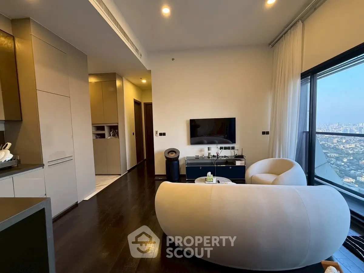 Modern living room with city view, featuring elegant furniture and sleek design.