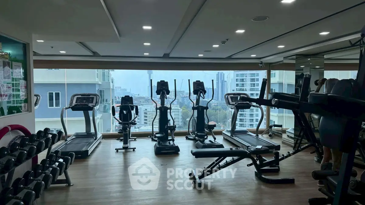 Modern gym with city view and state-of-the-art fitness equipment
