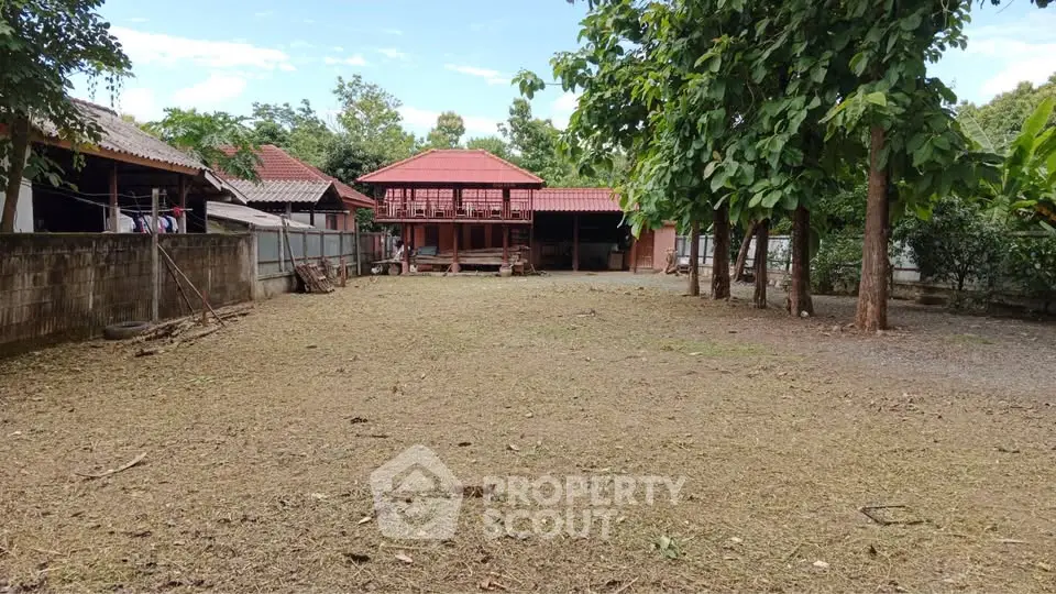 Spacious residential property with traditional architecture and large outdoor area, perfect for development.