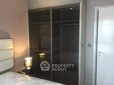 Modern bedroom with sleek wardrobe and stylish lighting