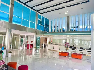 Spacious modern lobby with sleek design and vibrant seating in a commercial building.