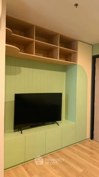 Modern living room with stylish TV unit and wooden shelves, perfect for contemporary homes.