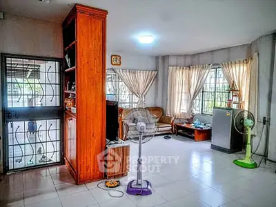 Spacious living room with natural light and modern furnishings