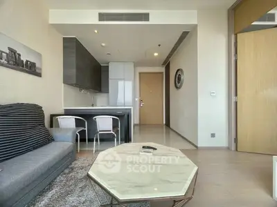 Modern living room with open kitchen layout and stylish furniture