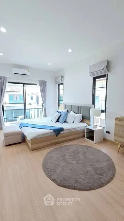 Spacious modern bedroom with large windows and stylish decor