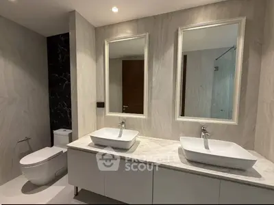 Luxurious modern bathroom with dual sinks and elegant marble finishes.
