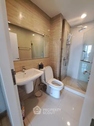 Modern bathroom with sleek fixtures and glass shower enclosure