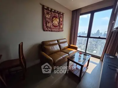 Modern living room with leather sofa and city view from large windows