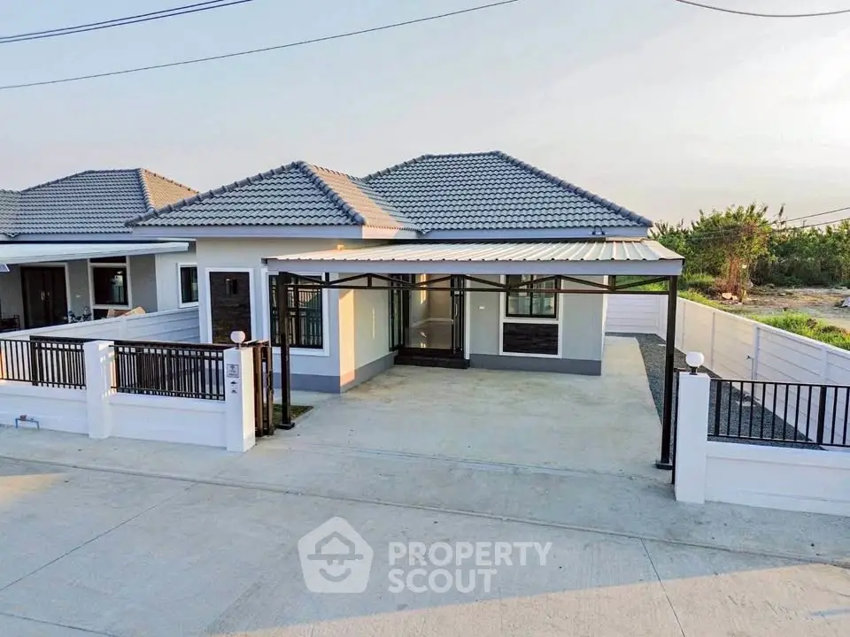Charming single-story home with modern design and spacious driveway in a serene neighborhood.