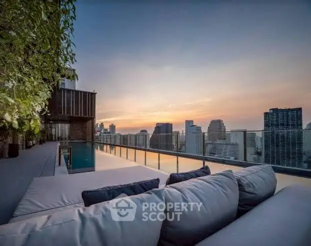 Luxurious rooftop terrace with stunning city skyline view at sunset, perfect for relaxation and entertainment.
