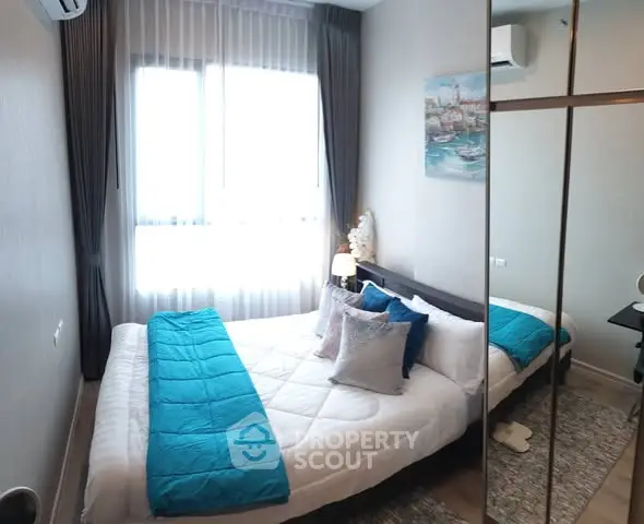 Cozy bedroom with modern decor and large mirrored wardrobe