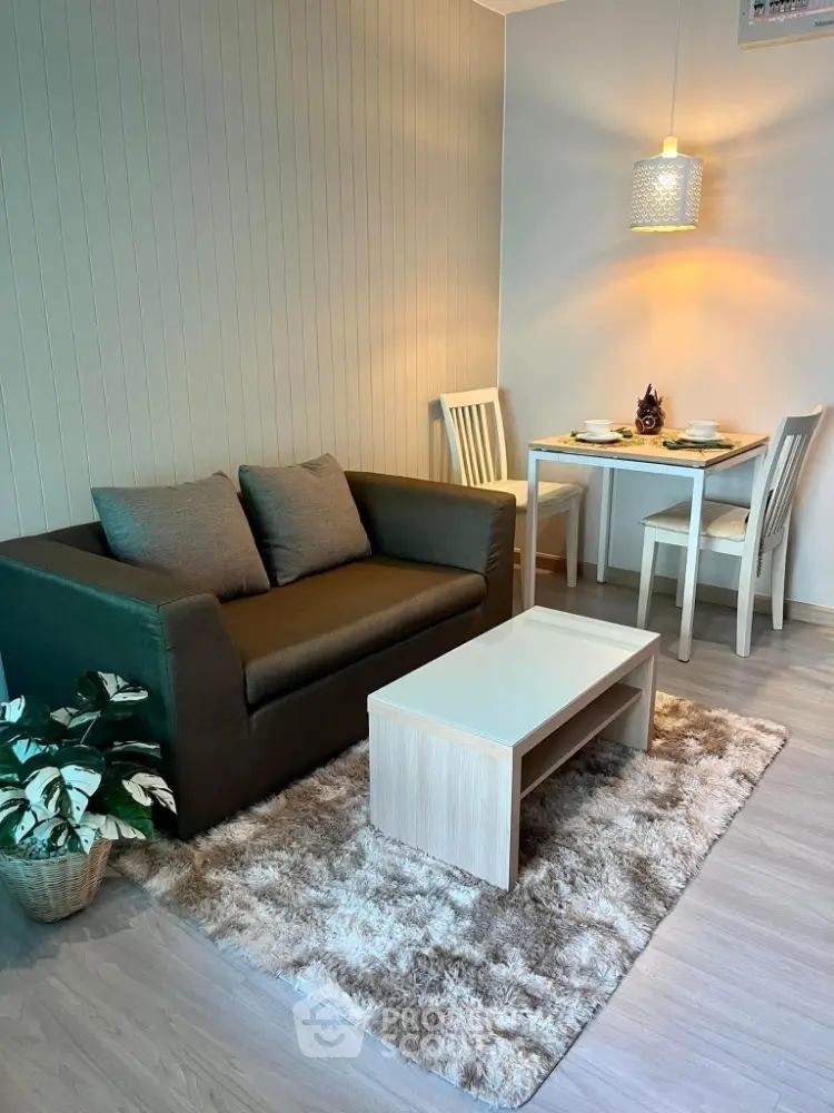 Cozy living room with modern decor and dining area, perfect for urban living.