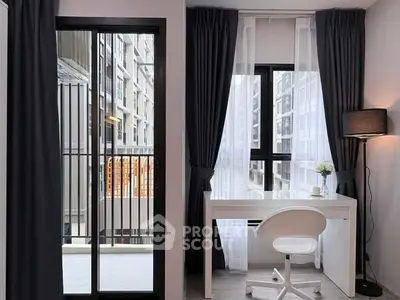 Modern study area with sleek desk and chair, large windows offering city view, and elegant curtains.