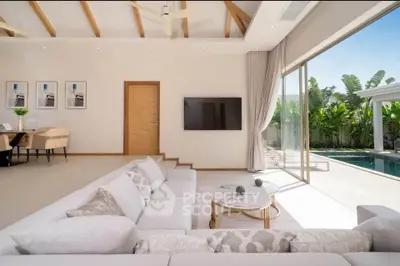 Luxurious living room with pool view and elegant decor in modern villa
