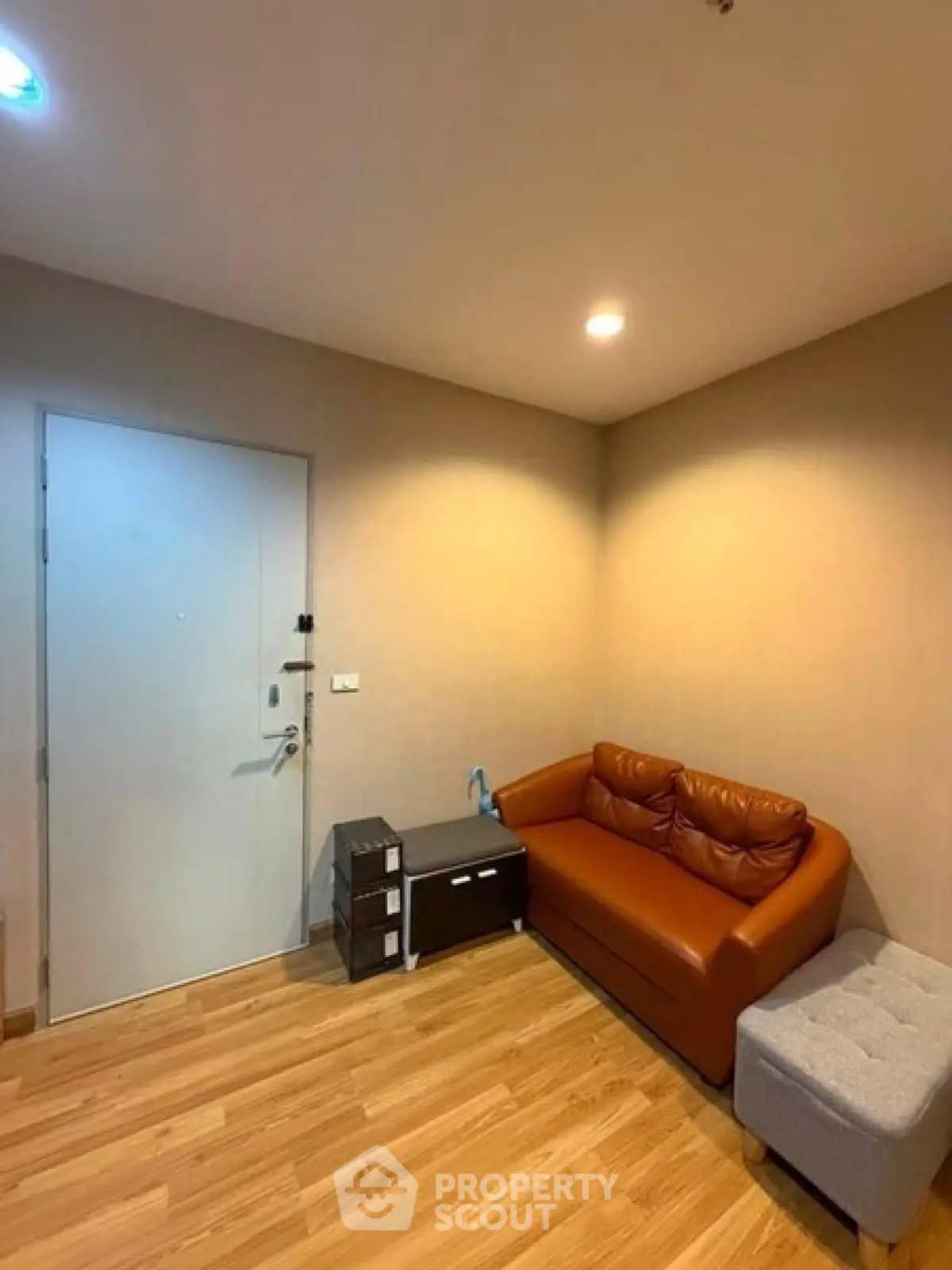 Cozy living room with modern furniture and wooden flooring in a stylish apartment.