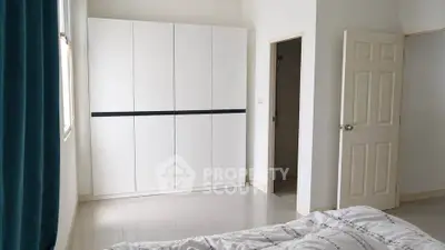 Spacious bedroom with modern wardrobe and natural light