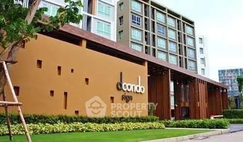 Modern condo building exterior with lush landscaping and contemporary design.