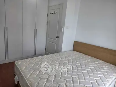 Cozy bedroom with fitted wardrobe and comfortable bed in modern apartment.