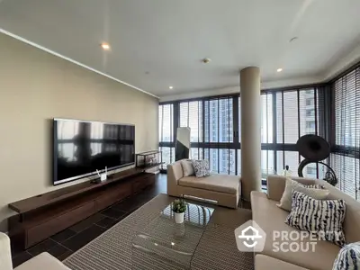 Spacious modern living room with large windows and stylish furniture in high-rise apartment.