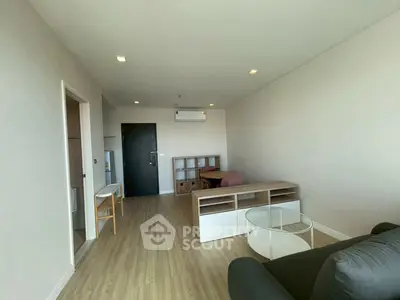 Spacious modern living room with minimalist decor and wooden flooring